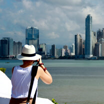 Tourist taking photos of Panama City Skyline from La Cinta Costera Tourist taking photos of Panama City Skyline from La Cinta Costera
