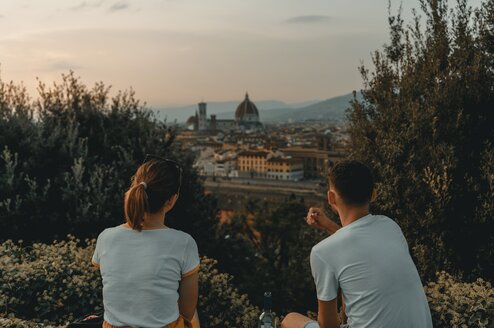 Two people sitting on a hill in Florence, Italy.